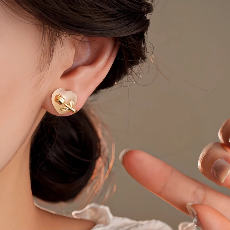 Close-up detail of the sparkling zircons and plating on the Heart Stud Earrings