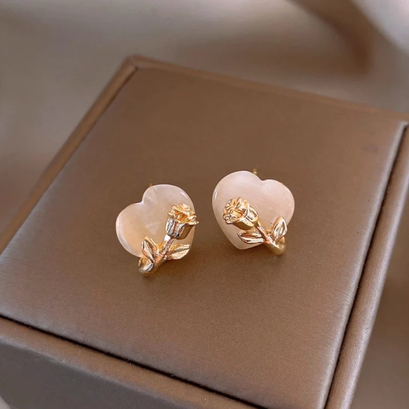 Angled view of the 14K Gold-Plated Rose Heart Stud Earrings