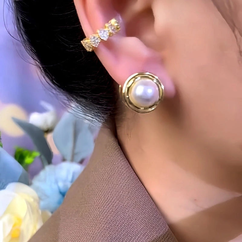 Model showcasing the dangle and style of the 14K Gold-Plated Round Pearl Earrings