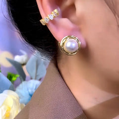 Model showcasing the dangle and style of the 14K Gold-Plated Round Pearl Earrings