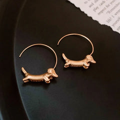 Angled view of the 14K Gold-Plated Sausage Dog Threader Earrings