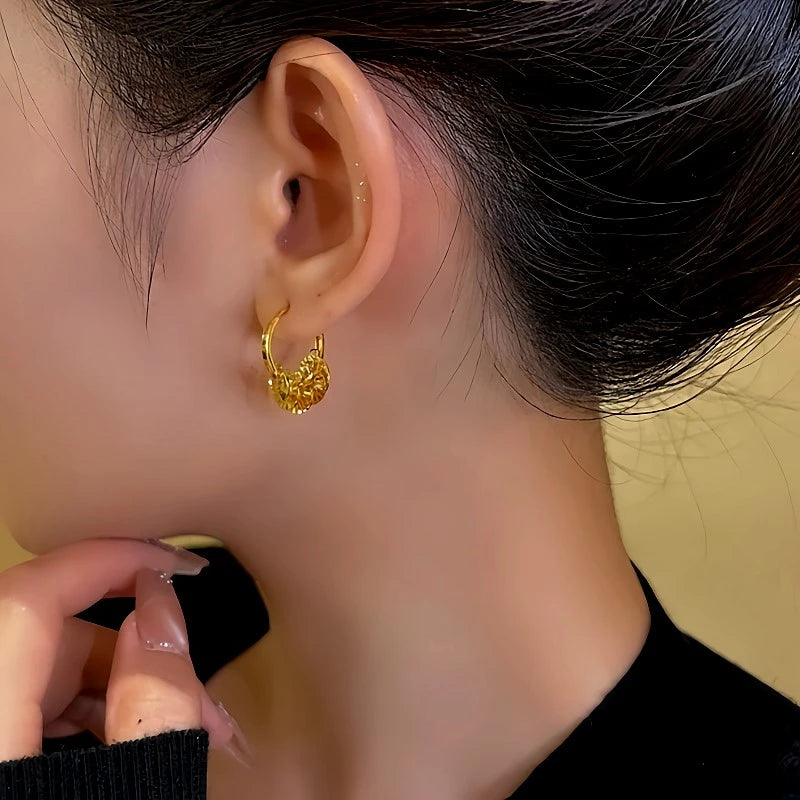 Model showcasing the dangle and style of the 14K Gold-Plated Sequin Hoop Tassel Earrings