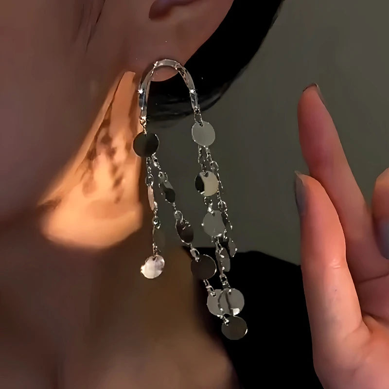 Model showcasing the dangle and style of the 14K Gold-Plated Sequin Tassel Earrings