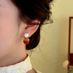 Close-up detail of the sparkling zircons and plating on the Shell Pearl Earrings