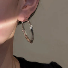 Model showcasing the dangle and style of the 14K Gold-Plated Silver Geometric Earrings