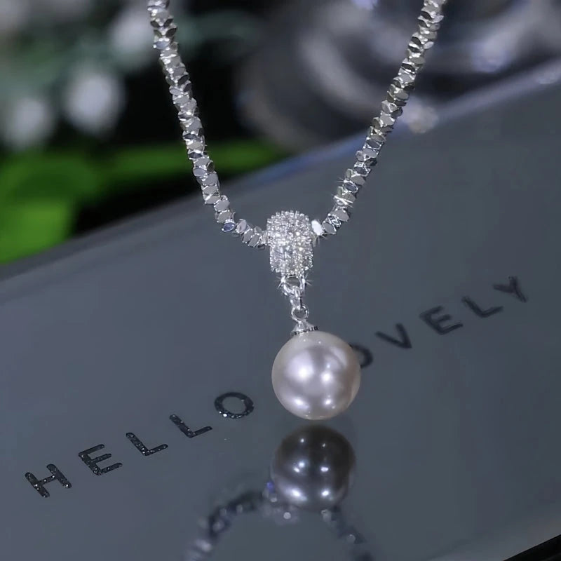 Detailed view of the 14K Gold-Plated Silver Pearl Earrings chain and pendant