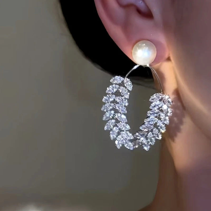Model showcasing the dangle and style of the 14K Gold-Plated Simple Beaded Wheat Earrings