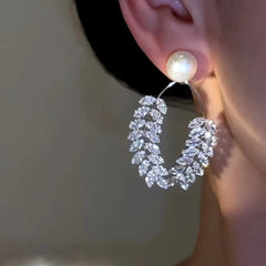 Model showcasing the dangle and style of the 14K Gold-Plated Simple Beaded Wheat Earrings