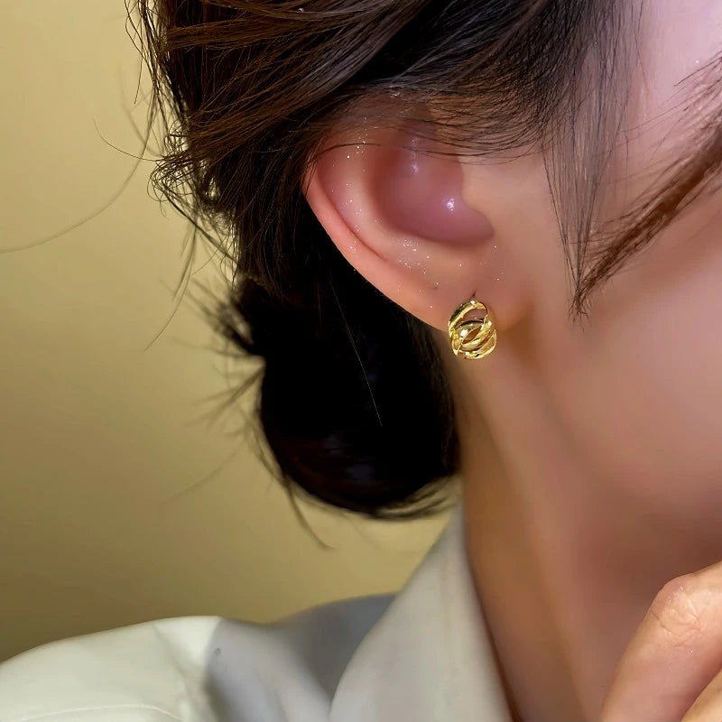 Model showcasing the dangle and style of the 14K Gold-Plated Small Chain Hoop Earrings