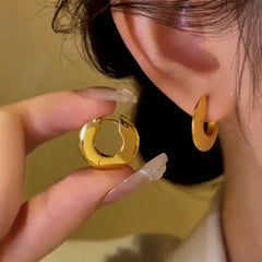 Angled view of the 14K Gold-Plated Smooth Flat Hoop Earrings