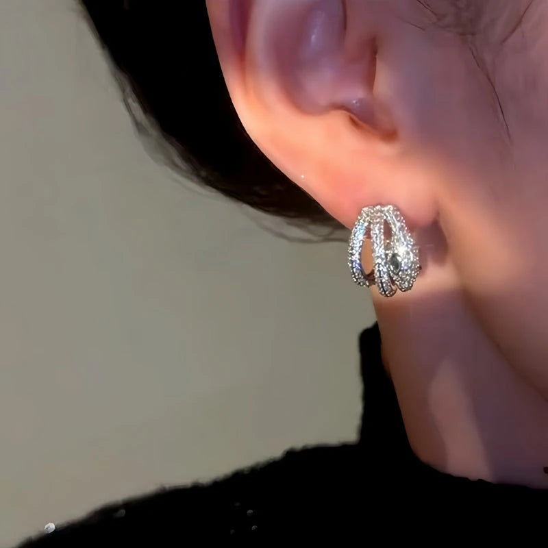 Model showcasing the dangle and style of the 14K Gold-Plated Snake-Design Earrings
