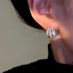 Model showcasing the dangle and style of the 14K Gold-Plated Snake-Design Earrings