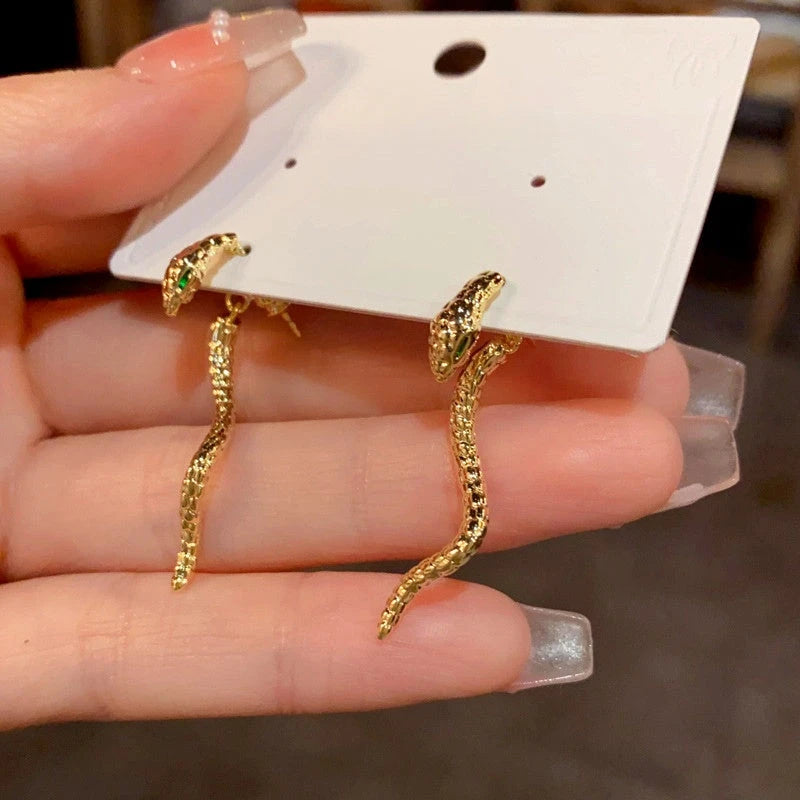 Model showcasing the dangle and style of the 14K Gold-Plated Snake-Shaped Earrings