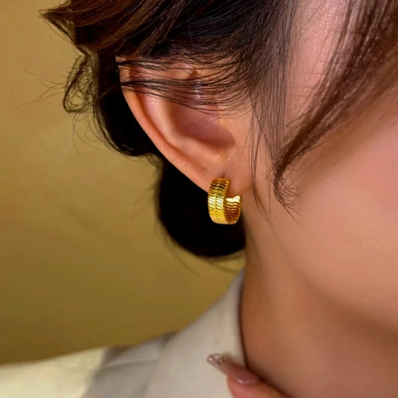 Close-up detail of the sparkling zircons and plating on the Snake Hoop Earrings