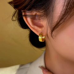Close-up detail of the sparkling zircons and plating on the Snake Hoop Earrings