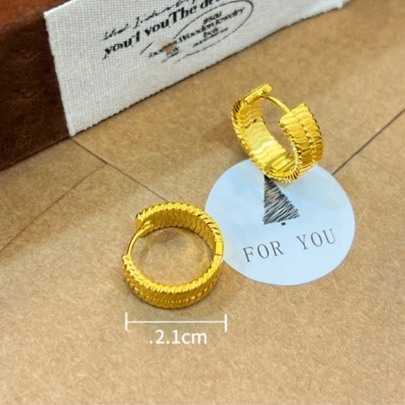 Angled view of the 14K Gold-Plated Snake Bone Pattern Little Hoop Earrings