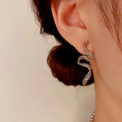 Silver twisted snake drop earring worn on pierced ear