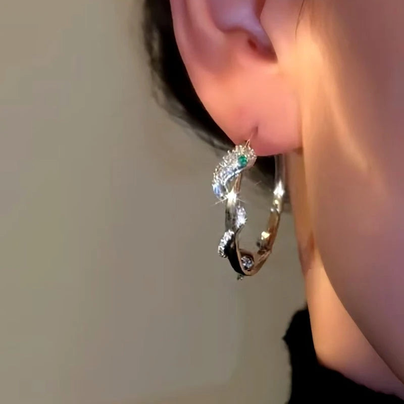 Close-up detail of the sparkling zircons and plating on the Snake Hoop Earrings