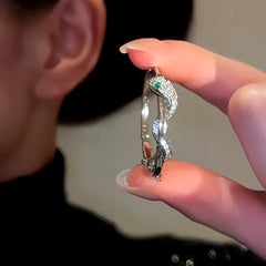 Model showcasing the dangle and style of the 14K Gold-Plated Snake Hoop Earrings