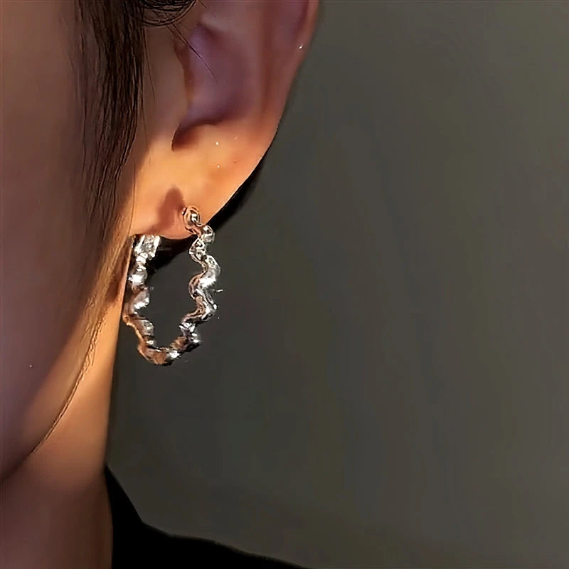 Model showcasing the dangle and style of the 14K Gold-Plated Sparkling Diamond Hoop Earrings