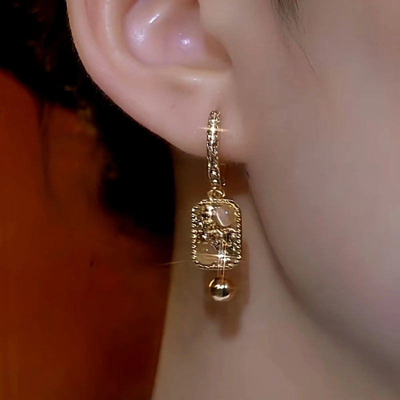 Close-up detail of the sparkling zircons and plating on the Cat's Eye Earrings