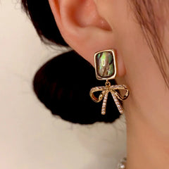 Close-up detail of the sparkling zircons and plating on the Shell Bow Earrings