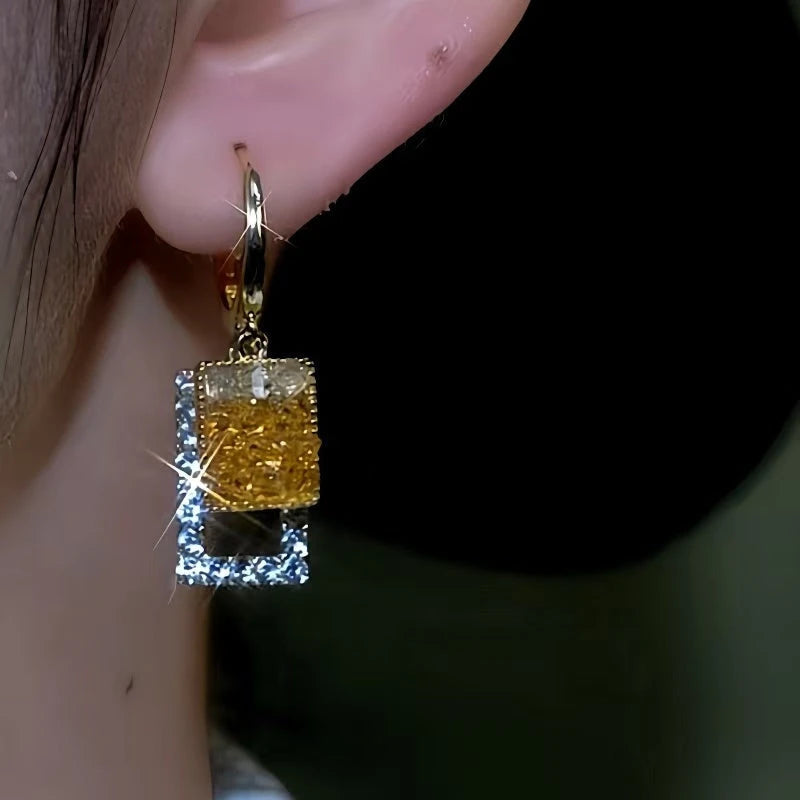 Model showcasing the dangle and style of the 14K Gold-Plated Square Crystal Earrings