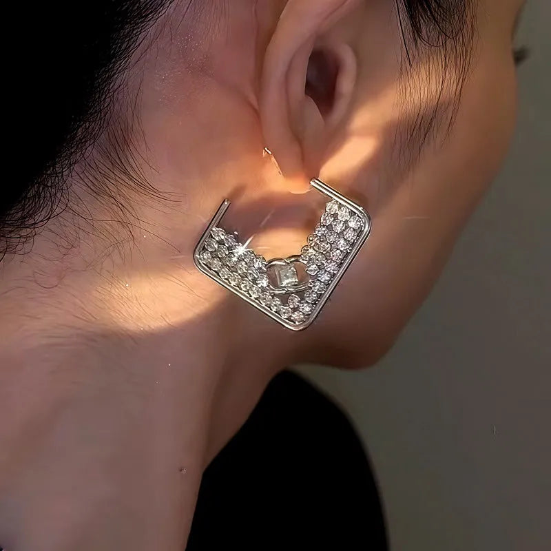 Model showcasing the dangle and style of the 14K Gold-Plated Square Diamond Earrings