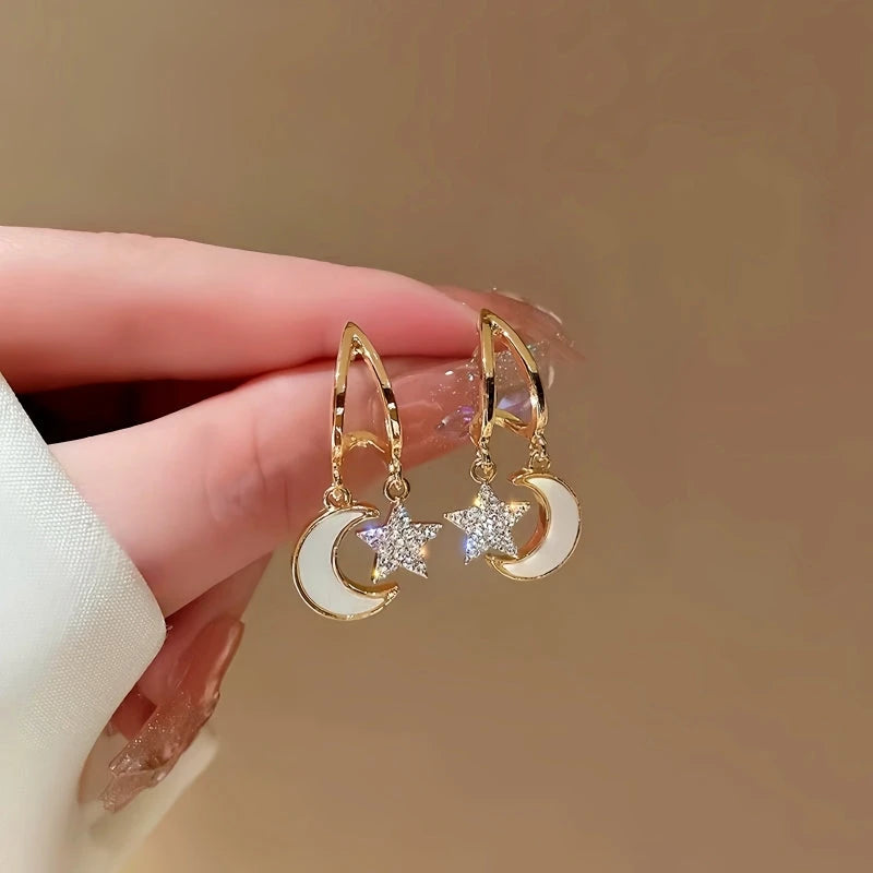 Angled view of the 14K Gold-Plated Star And Moon Earrings