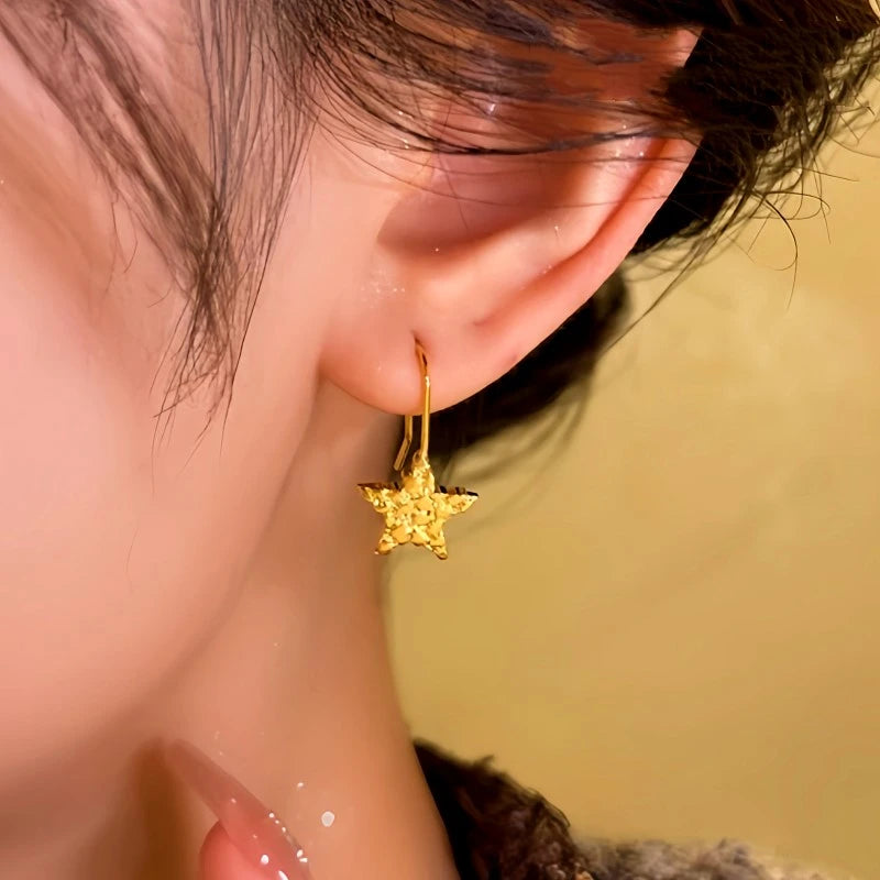 Model showcasing the dangle and style of the 14K Gold-Plated Star Ear Hook Earrings