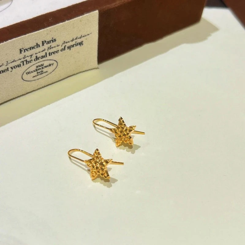 Angled view of the 14K Gold-Plated Star Ear Hook Earrings