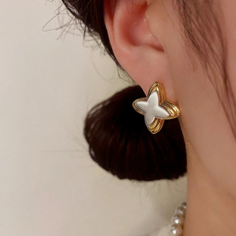 Close-up detail of the sparkling zircons and plating on the Star Stud Earrings