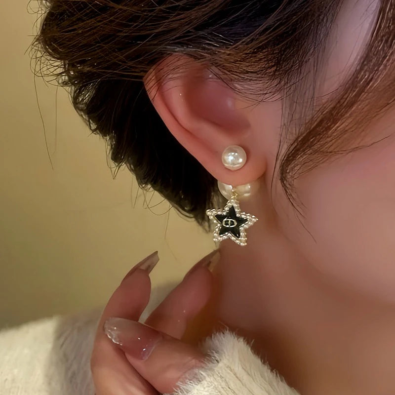 Model showcasing the dangle and style of the 14K Gold-Plated Star Tassel Bead Earrings
