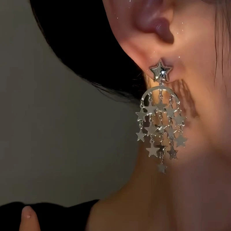 Model showcasing the dangle and style of the 14K Gold-Plated Star Tassel Earrings