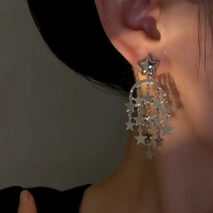 Model showcasing the dangle and style of the 14K Gold-Plated Star Tassel Earrings
