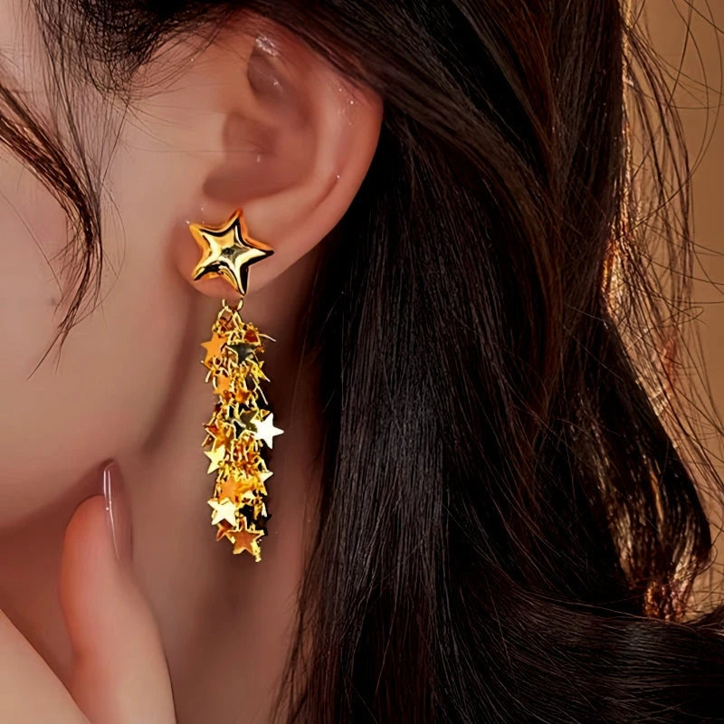 Model showcasing the dangle and style of the 14K Gold-Plated Star Tassel Earrings