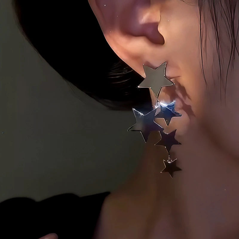 Model showcasing the dangle and style of the 14K Gold-Plated Star Tassel Earrings