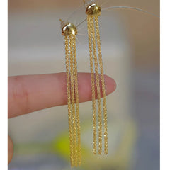 Angled view of the 14K Gold-Plated Starry Sky Tassel Earrings