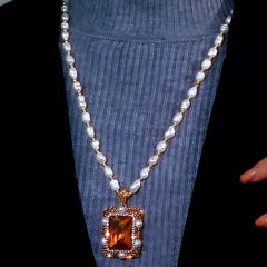 Close-up of the pendant and clasp on the Pearl Sweater Necklace