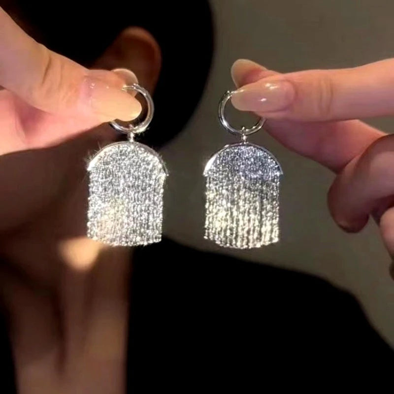 Angled view of the 14K Gold-Plated Tassel Pendant Earrings