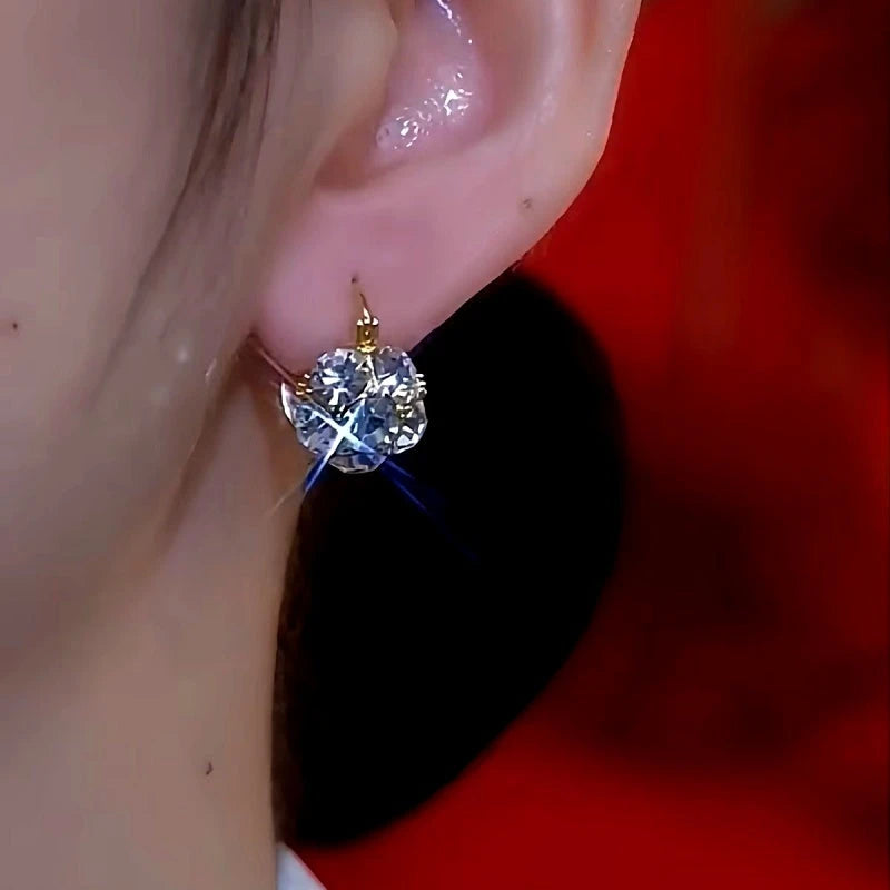 Model showcasing the dangle and style of the 14K Gold-Plated Tetro Pearl Earrings