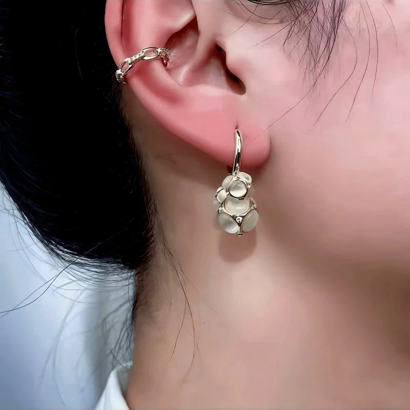 Angled view of the 14K Gold-Plated Three Cat-Eye Ball Earrings
