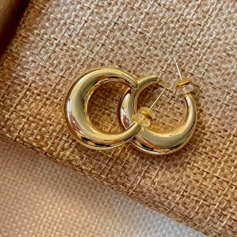 Model showcasing the dangle and style of the 14K Gold-Plated Trending C-Shaped Earrings