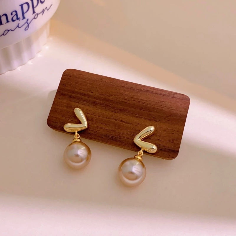 Close-up detail of the sparkling zircons and plating on the Heart Pearl Earrings