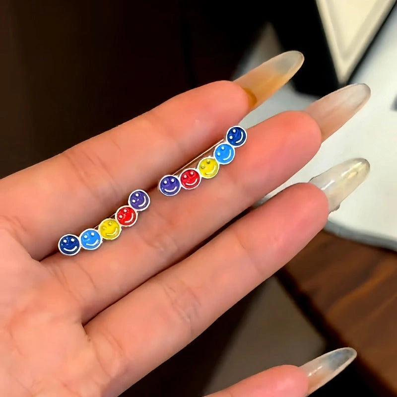 Angled view of the 14K Gold-Plated Trendy Rainbow Smiley Face Crawler Earrings