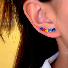 Model showcasing the dangle and style of the 14K Gold-Plated Trendy Rainbow Smiley Face Crawler Earrings