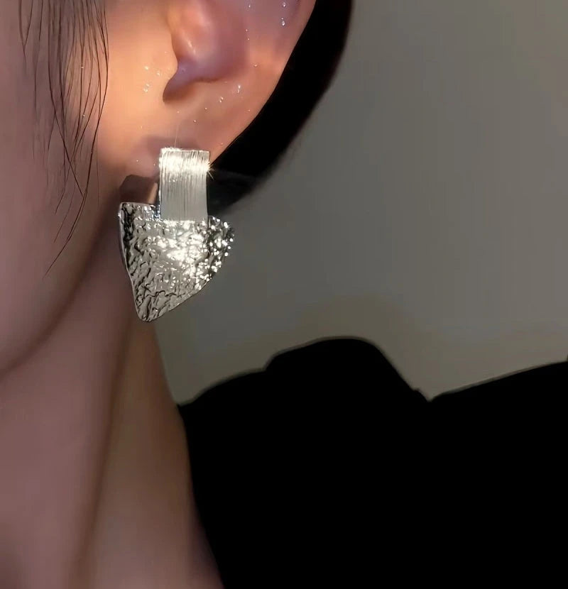 Close-up detail of the sparkling zircons and plating on the Triangle Earrings