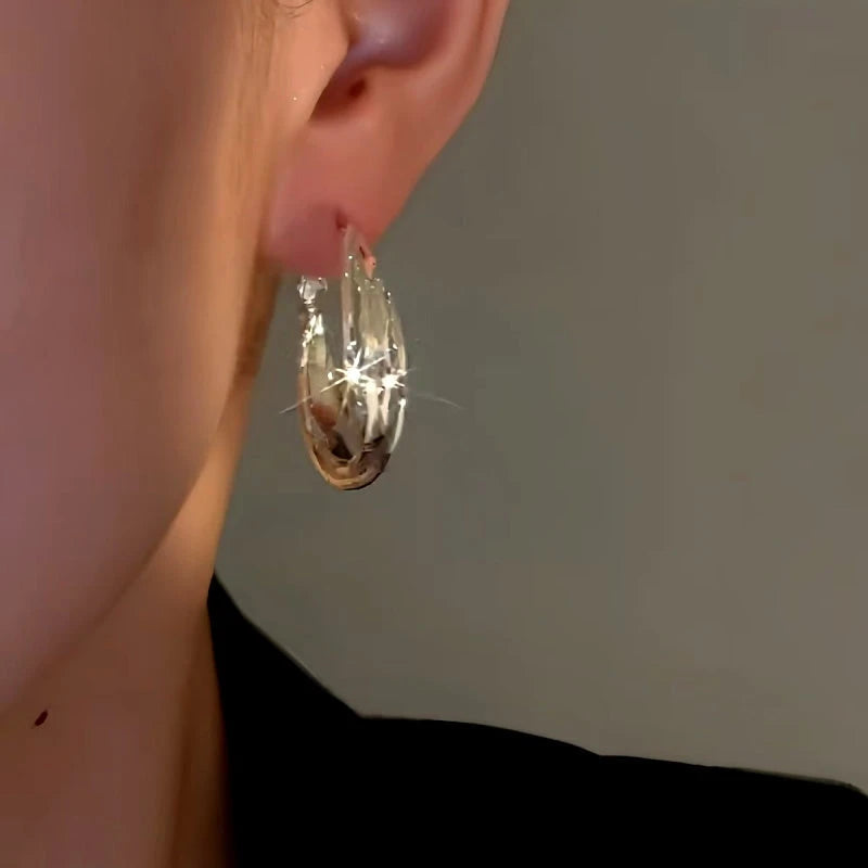 Close-up detail of the sparkling zircons and plating on the Twist Hoop Earrings
