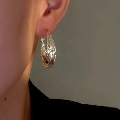 Close-up detail of the sparkling zircons and plating on the Twist Hoop Earrings