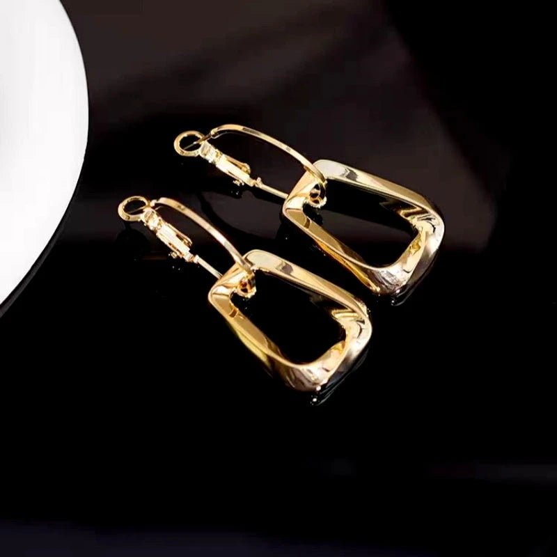 Close-up detail of the sparkling zircons and plating on the Twisted Gold Earrings